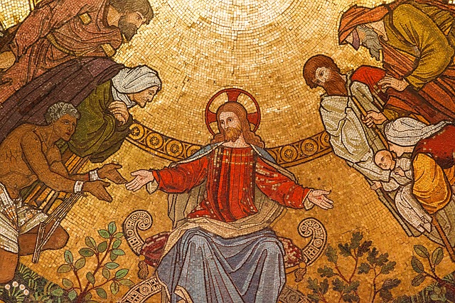 A close up of a mosaic depicting Jesus with His followers. His hands are outstretched and He may be sitting. On either side of Him are all sorts of people. Middle-aged men, a widow, a mother and her child, a slave, and more.