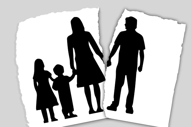 A black and white illustration showing a family holding hands together. Everyone in it is represented as a silhouette. Unfortunately, the image is torn. The husband that was once holding hands with his wife is torn from the rest of the image.