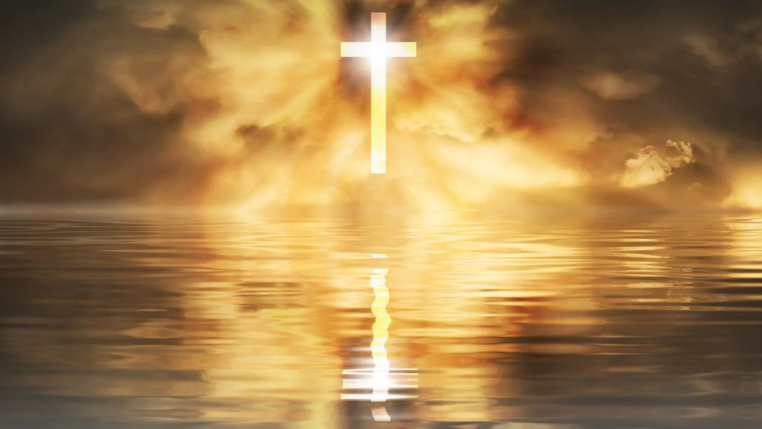A shining cross is floating over a tranquil body of water. Behind the cross are some distinctive red clouds.