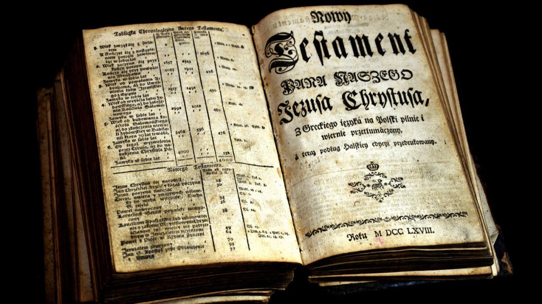 An open Bible written in a Gothic script. It may be opened to one of the Gospel accounts, or the New Testament in general.