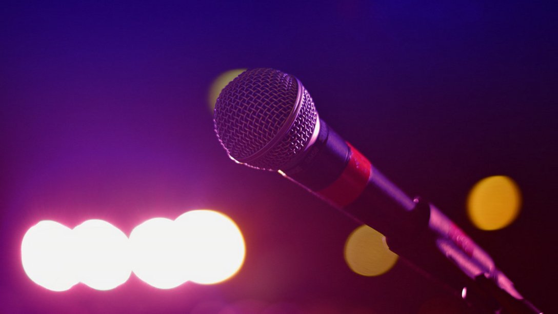 A microphone with bright lights in the background.