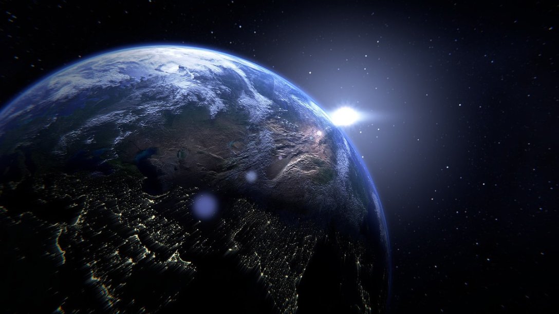 A light shining on the side of the globe of the earth